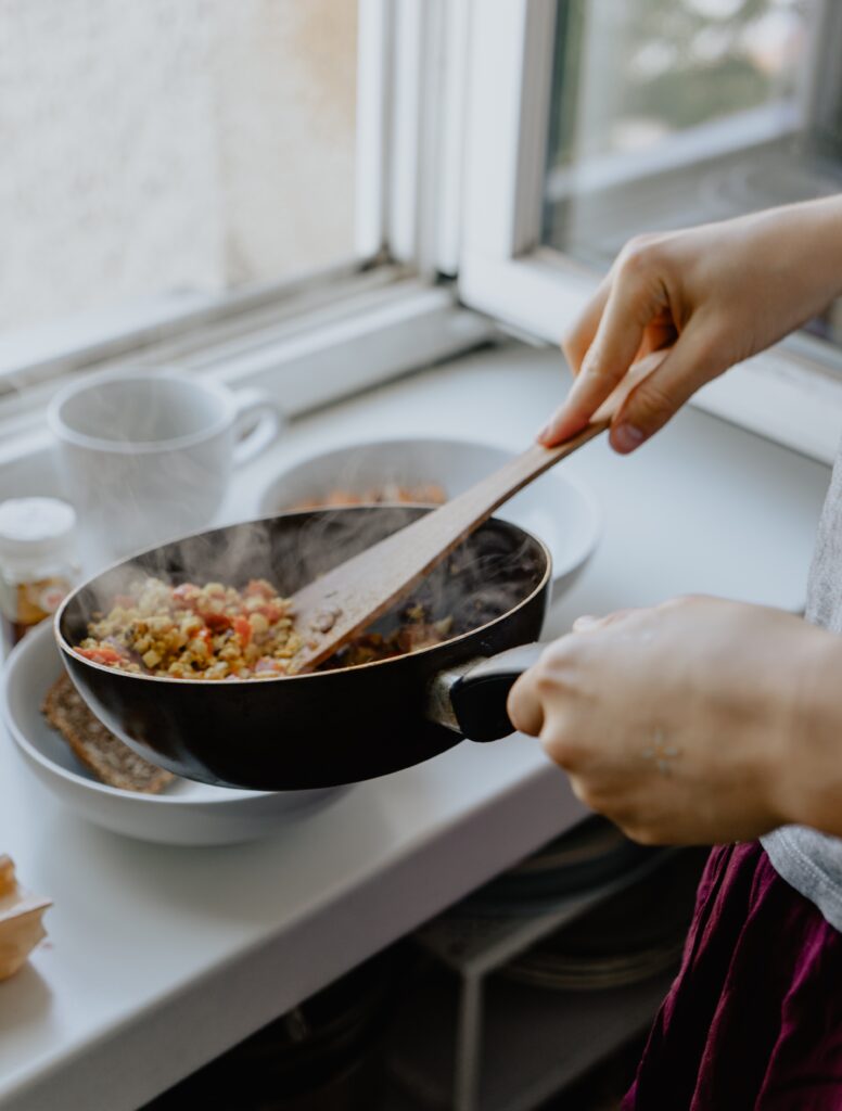 Person cooking homemade meals.